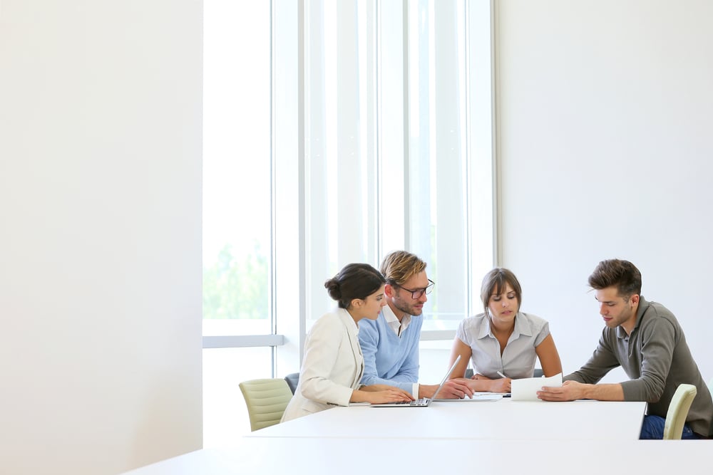 Business people meeting around table in modern space